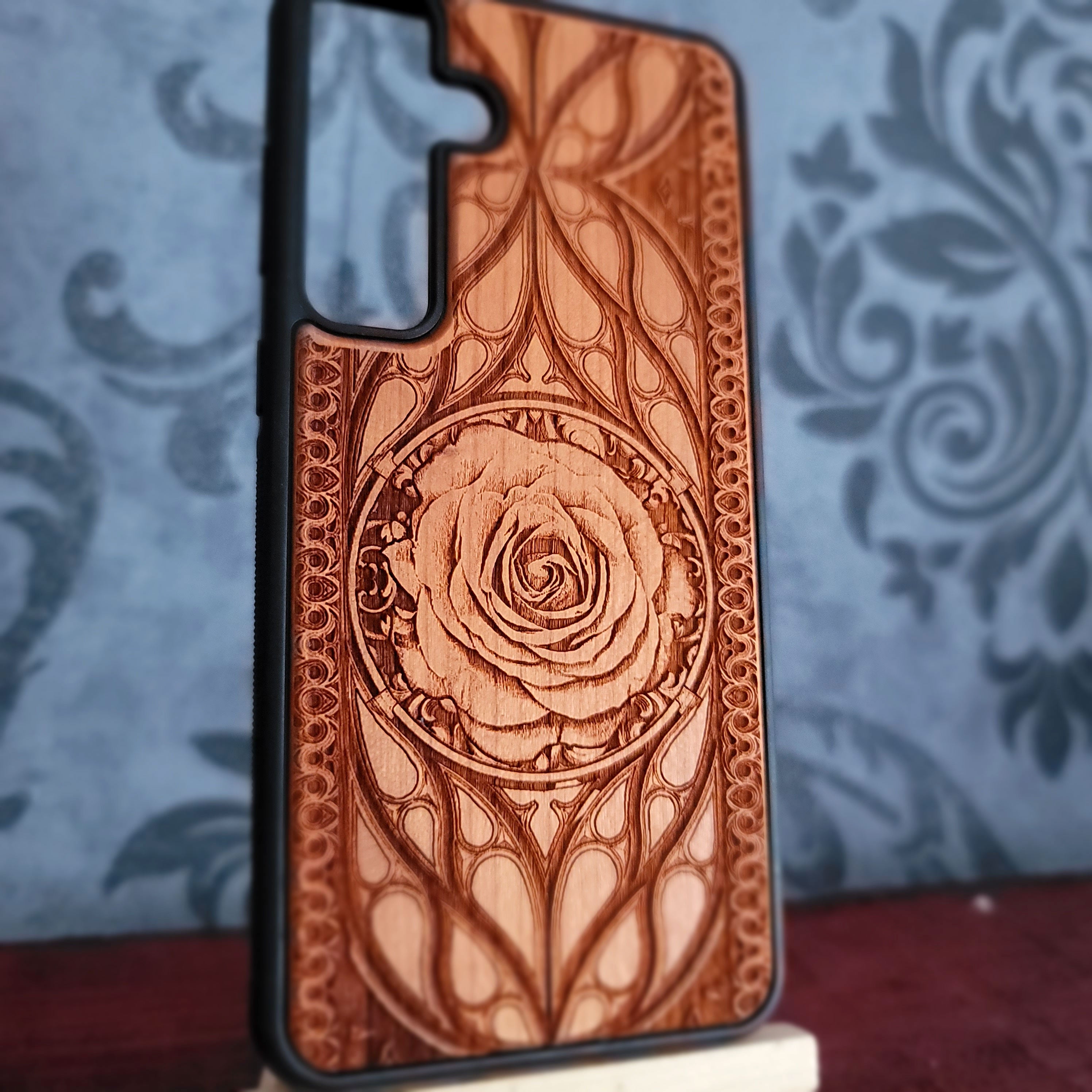 Laser-engraved wooden phone case with intricate rose design, slim, durable
