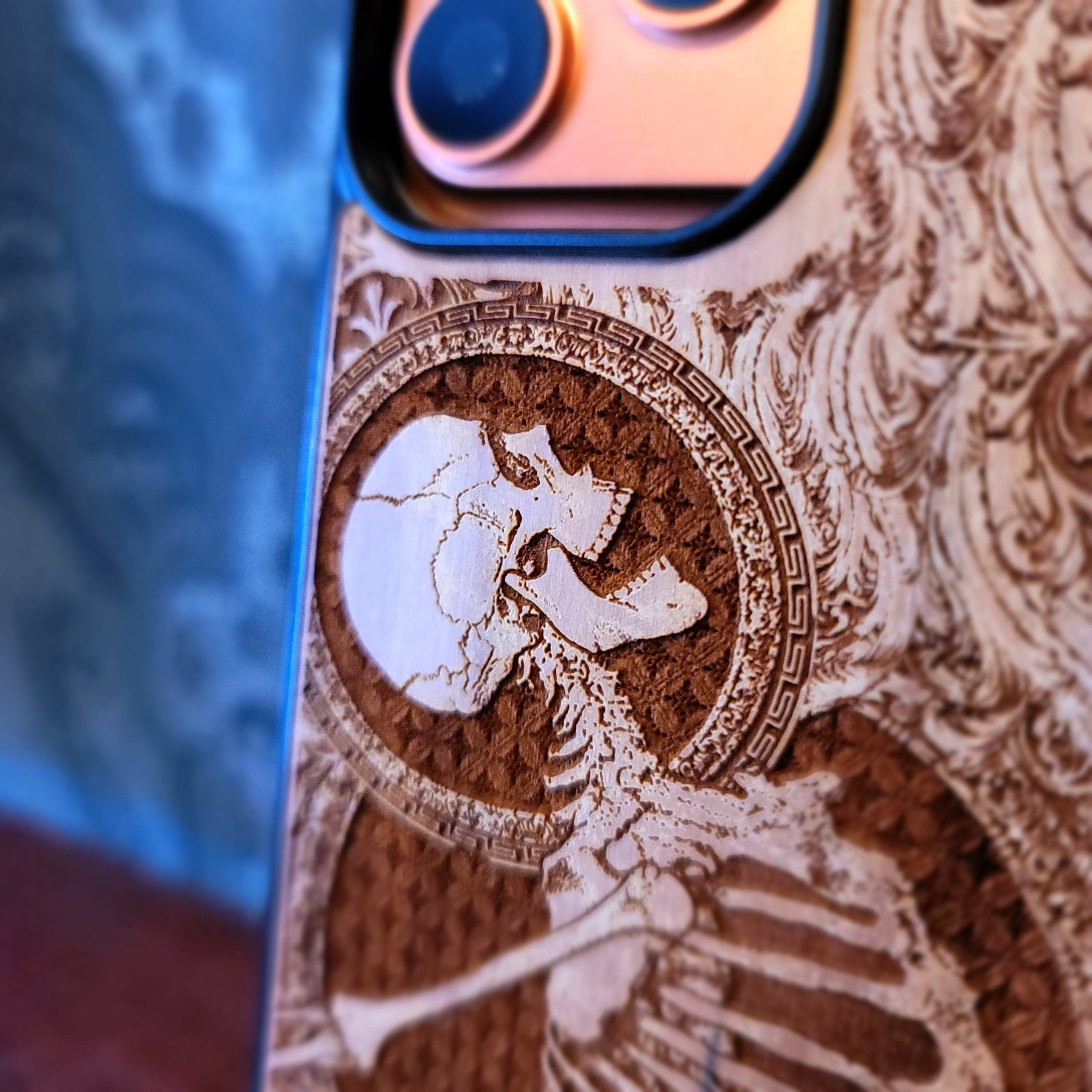 Deep laser engraved wooden phone case featuring a happy skeleton design on natural wood for iPhone and Samsung Galaxy models.