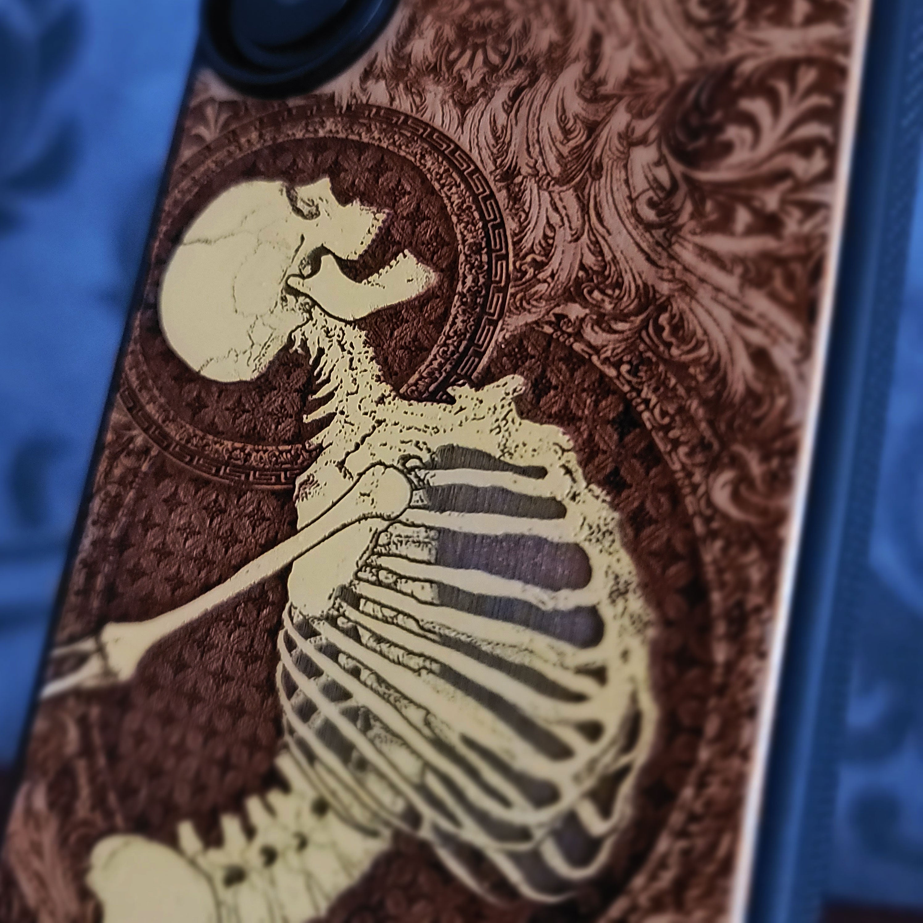 Cherry wood phone case with laser-engraved Gothic skeleton design for iPhone & Samsung Galaxy.