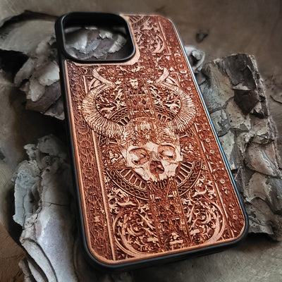 Gothic wooden phone case featuring an intricate skull and horns design. Handcrafted for iPhone  and Galaxy S, perfect for lovers of gothic art and unique phone accessories.