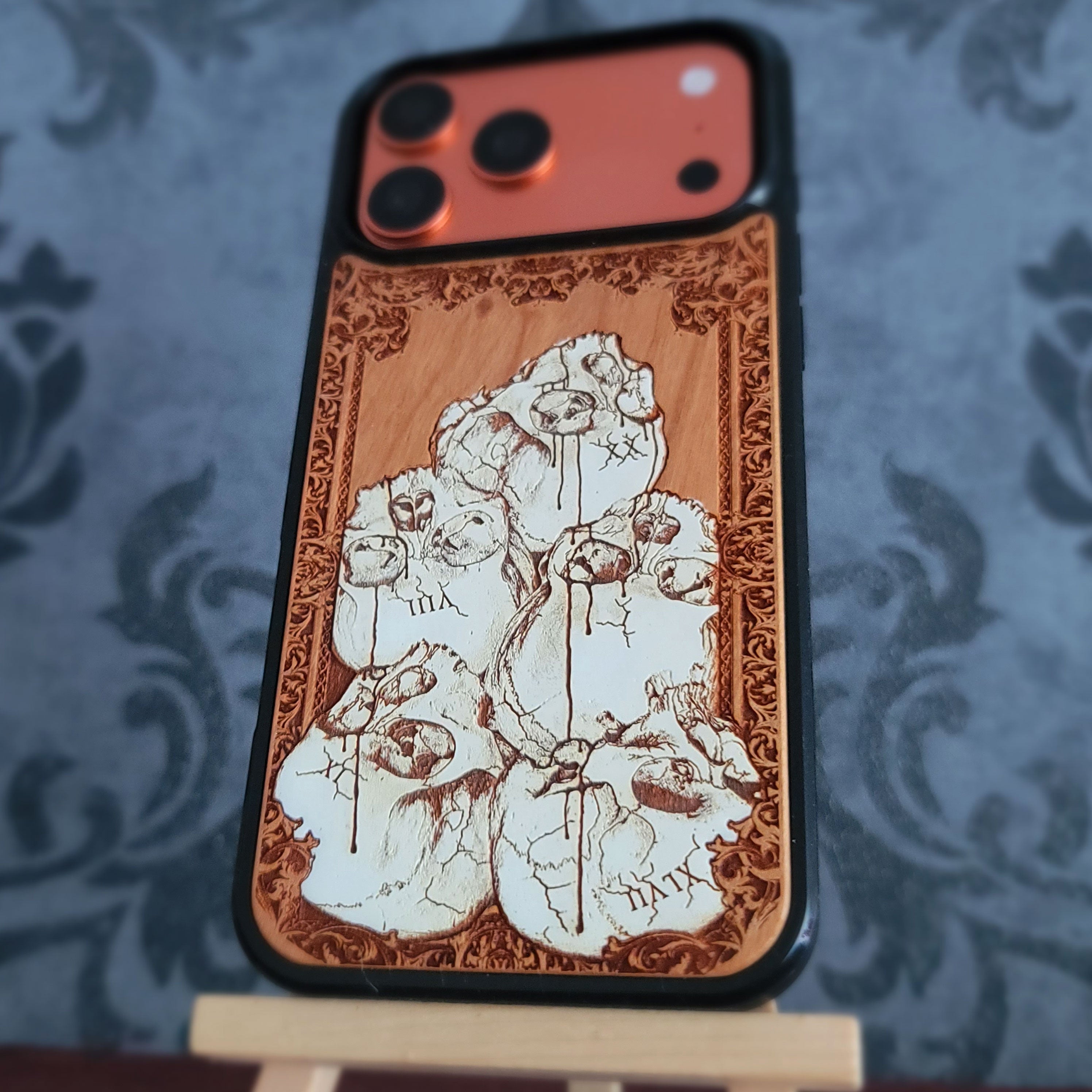 Hand-painted gothic wood phone case with stacked skulls and dripping details, compatible with iPhone and Galaxy, dark horror design.
