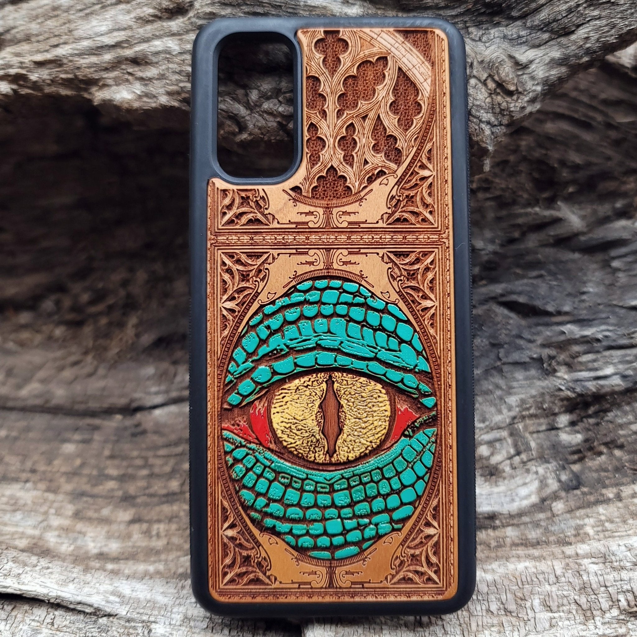 Gothic snake eye artwork engraved on a wooden phone case, compatible with iPhone  and Samsung Galaxy S.