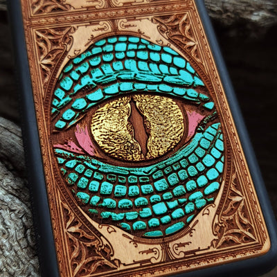 Gothic snake eye artwork engraved on a wooden phone case, compatible with iPhone  and Samsung Galaxy S.