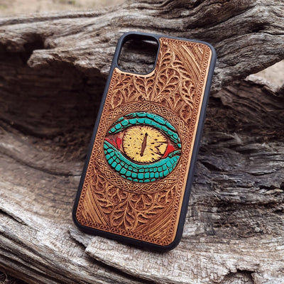 Close-up of intricate laser-engraved Snake Eye Gothic artwork on cherry wood phone case for iPhone & Samsung Galaxy