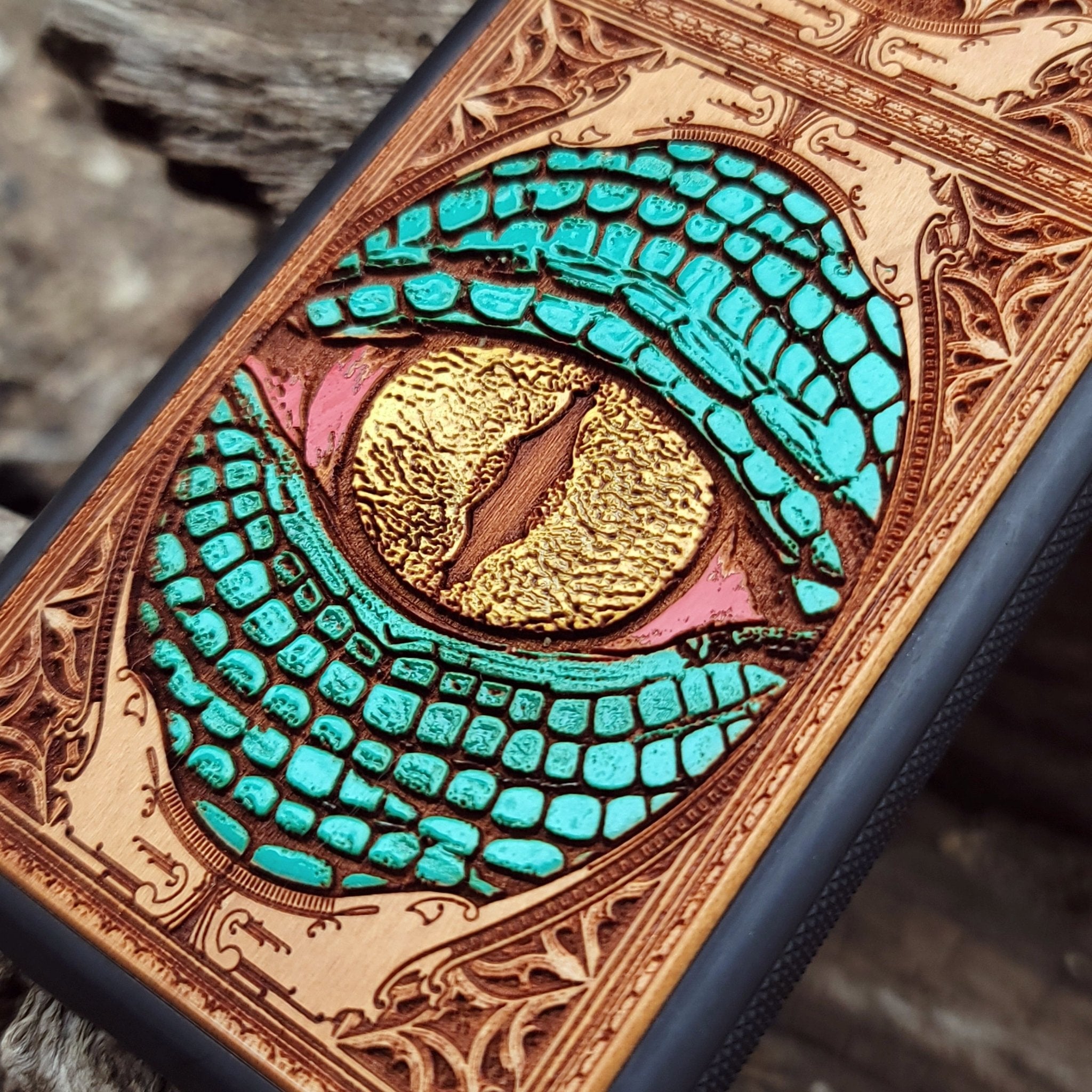 Gothic snake eye artwork engraved on a wooden phone case, compatible with iPhone  and Samsung Galaxy S.