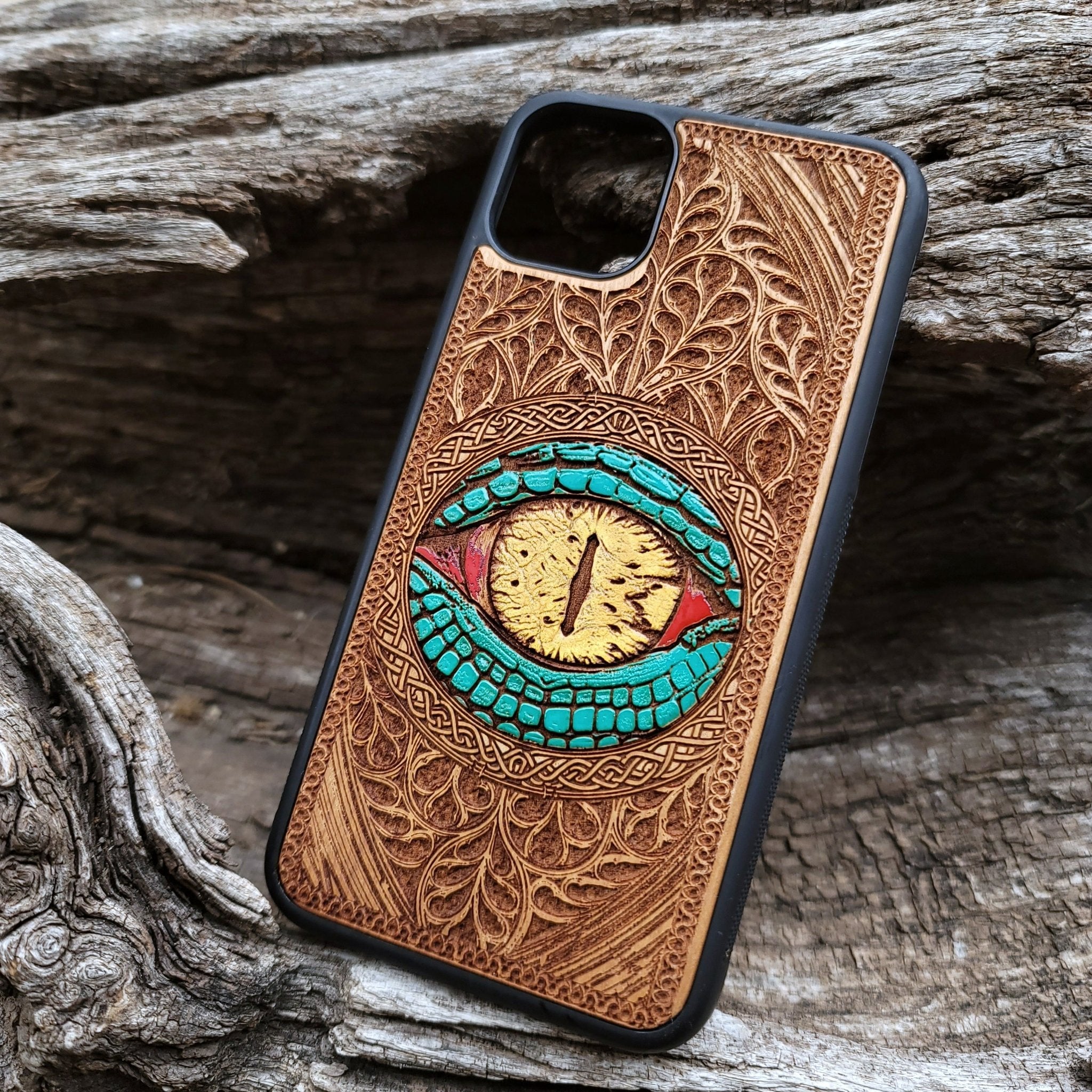 Close-up of intricate laser-engraved Snake Eye Gothic artwork on cherry wood phone case for iPhone & Samsung Galaxy