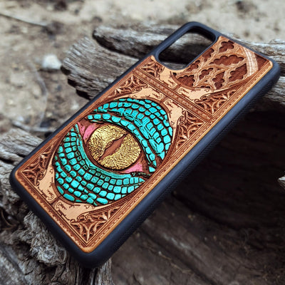 Gothic snake eye artwork engraved on a wooden phone case, compatible with iPhone  and Samsung Galaxy S.