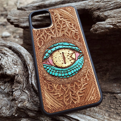 Close-up of intricate laser-engraved Snake Eye Gothic artwork on cherry wood phone case for iPhone & Samsung Galaxy