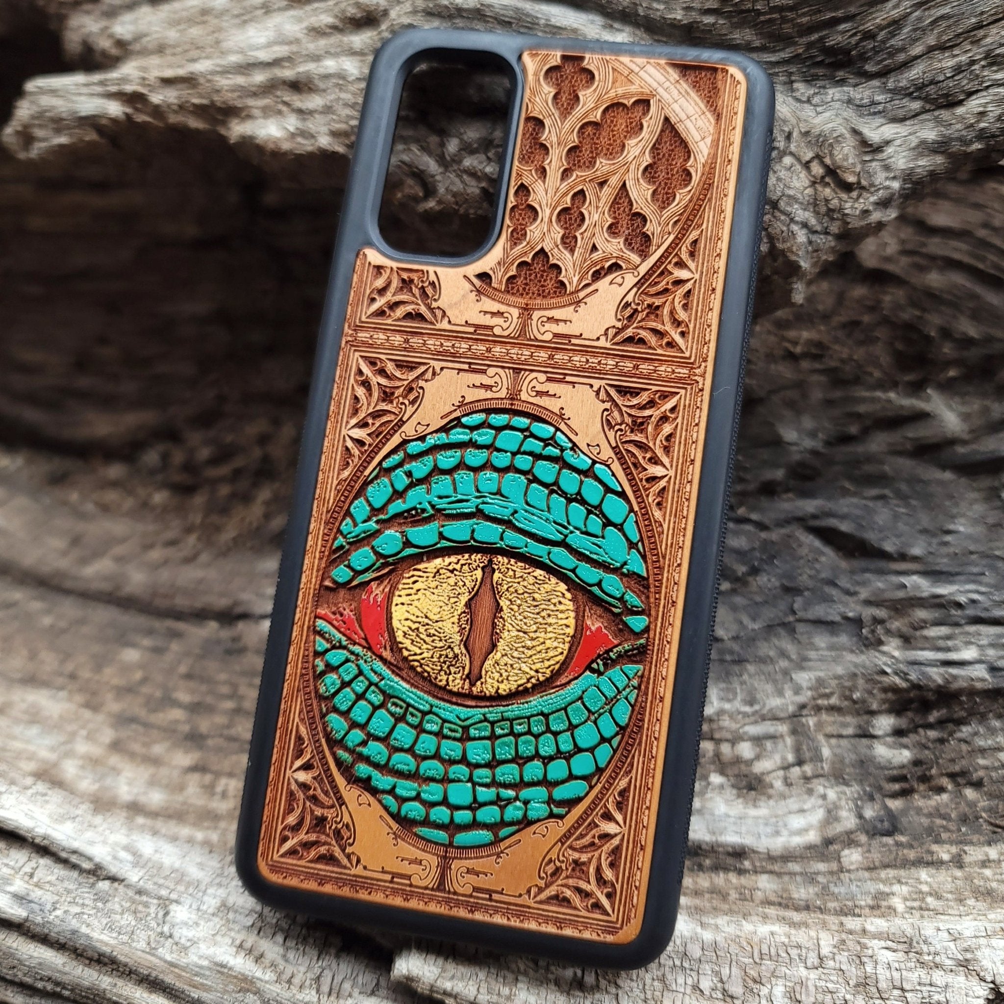 Gothic snake eye artwork engraved on a wooden phone case, compatible with iPhone  and Samsung Galaxy S.