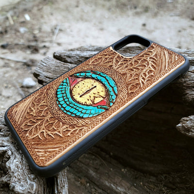 Close-up of intricate laser-engraved Snake Eye Gothic artwork on cherry wood phone case for iPhone & Samsung Galaxy