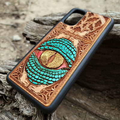 Gothic snake eye artwork engraved on a wooden phone case, compatible with iPhone  and Samsung Galaxy S.