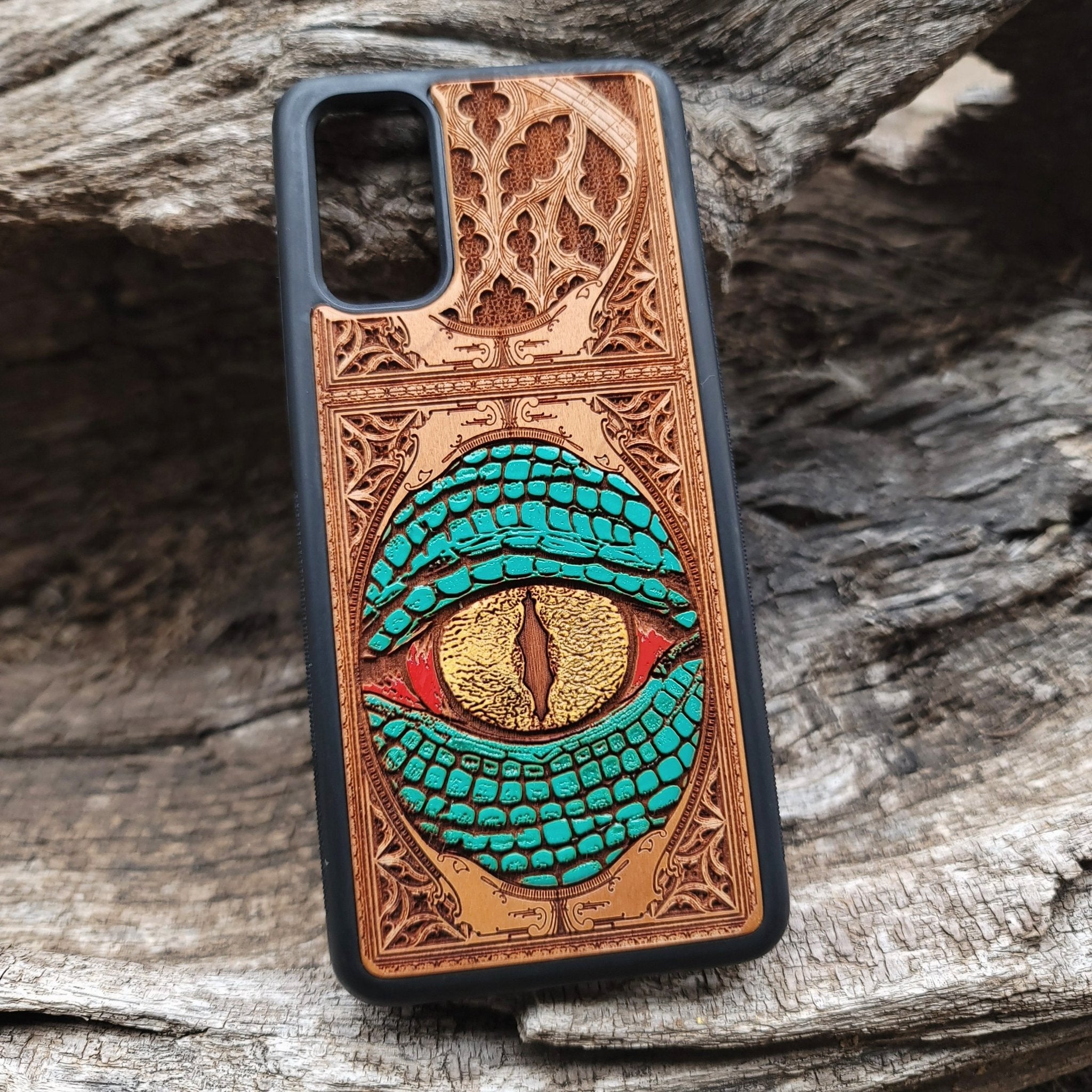 Gothic snake eye artwork engraved on a wooden phone case, compatible with iPhone  and Samsung Galaxy S.