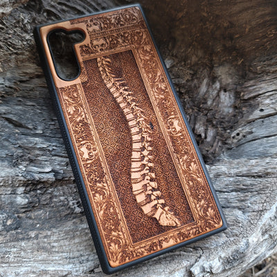 Wooden phone case with detailed skeleton spine carving, designed for iPhone , iPhone 15, Galaxy S, and other models. Perfect for lovers of gothic, anatomical art with premium protection.