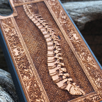 Wooden phone case with detailed skeleton spine carving, designed for iPhone , iPhone 15, Galaxy S, and other models. Perfect for lovers of gothic, anatomical art with premium protection.