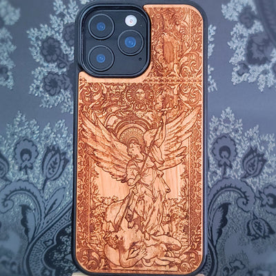 Deep laser engraved wooden phone case featuring Saint Michael Archangel fighting a demon with detailed religious artwork on natural wood for iPhone and Samsung Galaxy models.