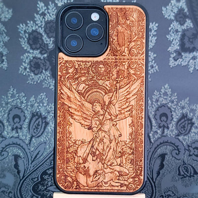 Deep laser engraved wooden phone case featuring Saint Michael Archangel fighting a demon with detailed religious artwork on natural wood for iPhone and Samsung Galaxy models.