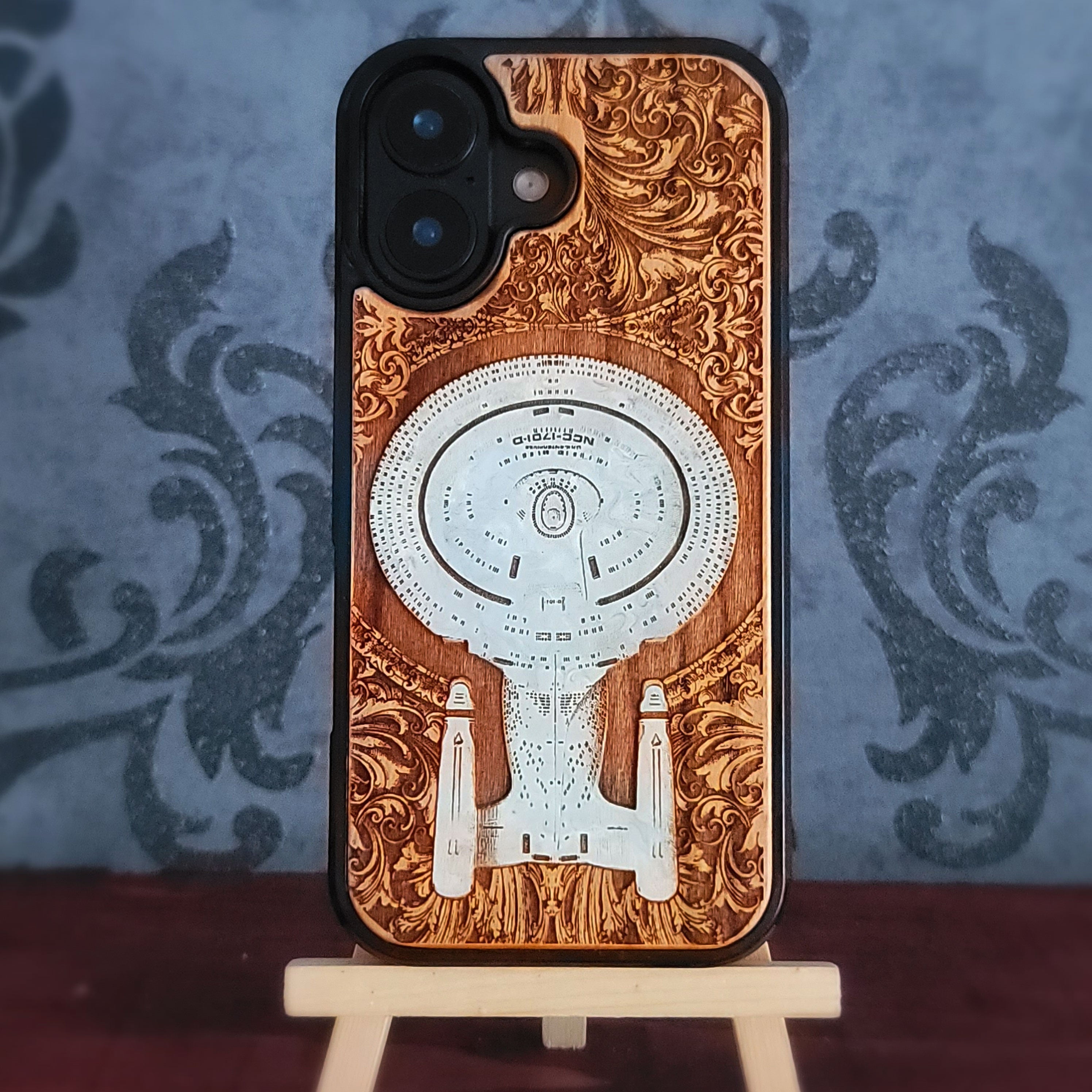 Enterprise NCC-1701-D hand-painted cherrywood phone case, close rear view of the white starship and scrollwork