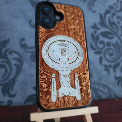 Enterprise NCC-1701-D hand-painted cherrywood phone case, side angle showing the raised protective edge