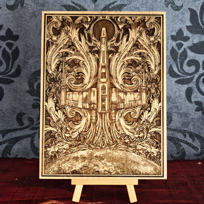 Wooden laser-cut artwork featuring a detailed depiction of a spaceship, surrounded by ornate, swirling floral patterns. The artwork is framed and has a natural wood color, with intricate details and a vintage aesthetic.