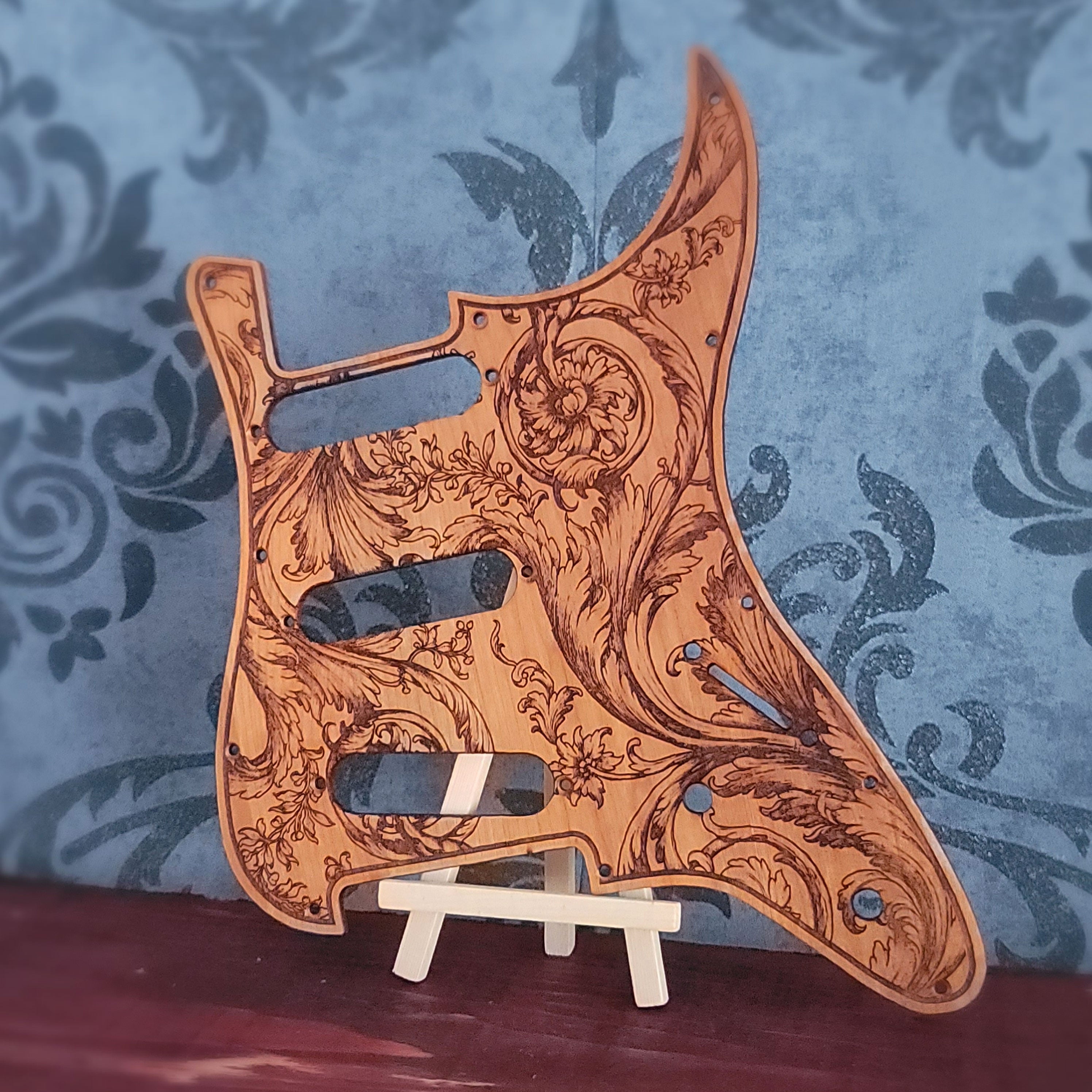 Custom wooden pickguard for Strato SSS & HSS guitars featuring a laser-engraved flourish design. Fits 8 or 11 screw holes, handcrafted for durability and style. A perfect artistic and unique gift for guitarists
