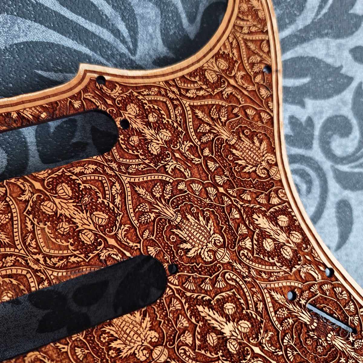 Natural wood Stratocaster pickguard with custom engraved design