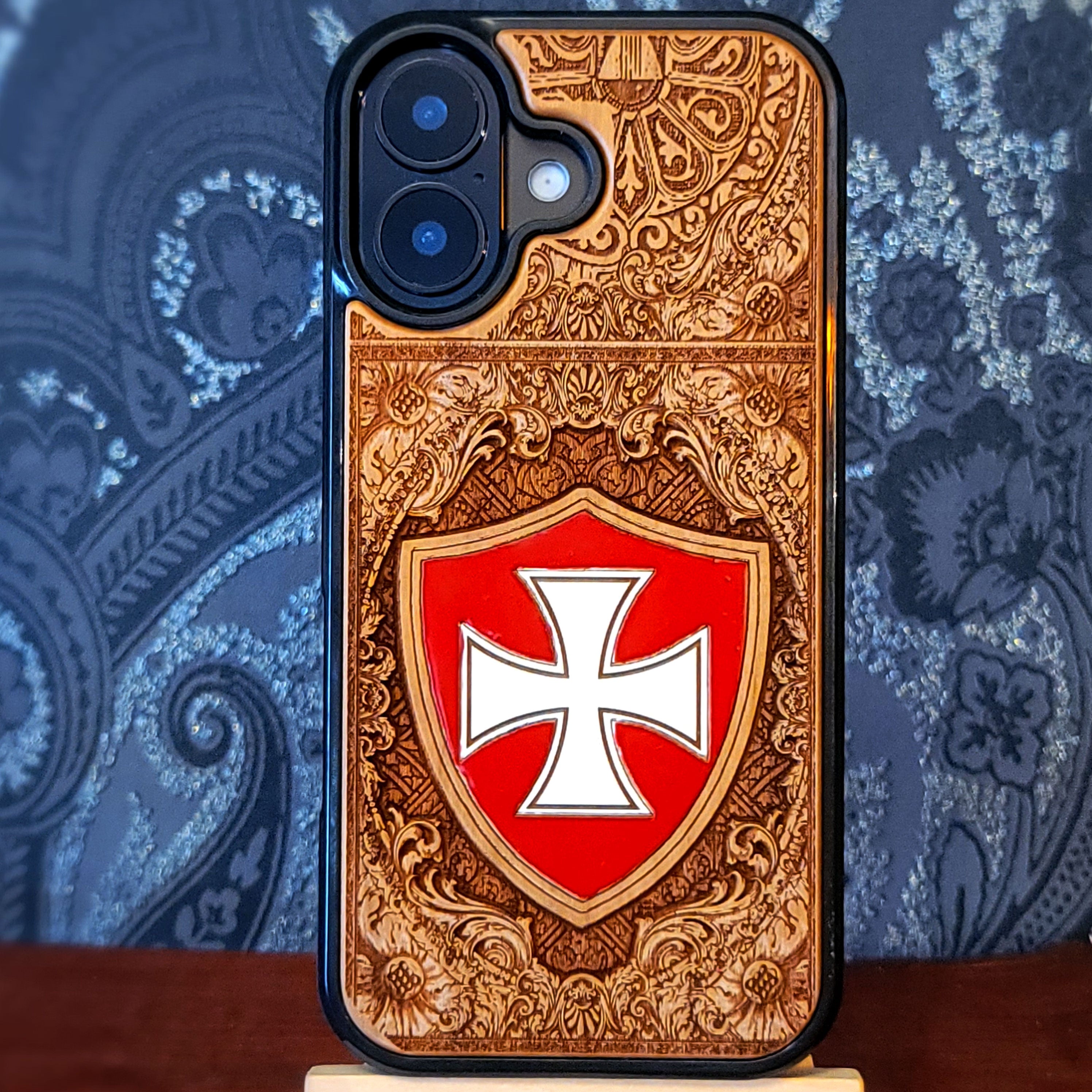 Deep laser engraved and hand painted wooden phone case featuring a medieval Templar cross design for iPhone and Samsung Galaxy models.