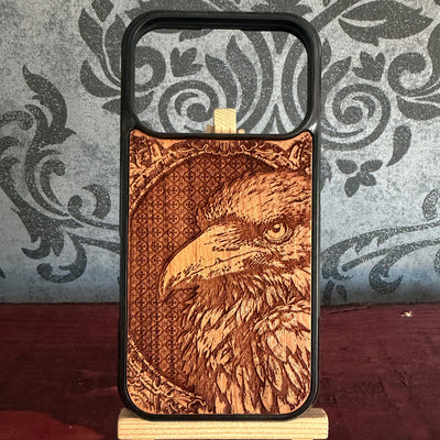 Detailed raven portrait laser engraved on real cherrywood phone case with ornate gothic frame