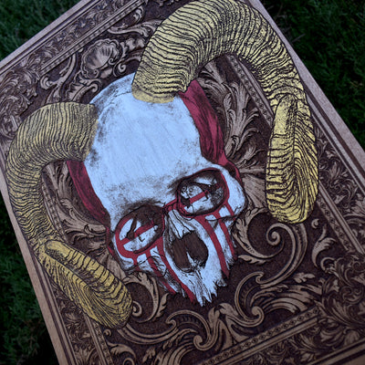 Handcrafted skull with horns on natural wood wall panel