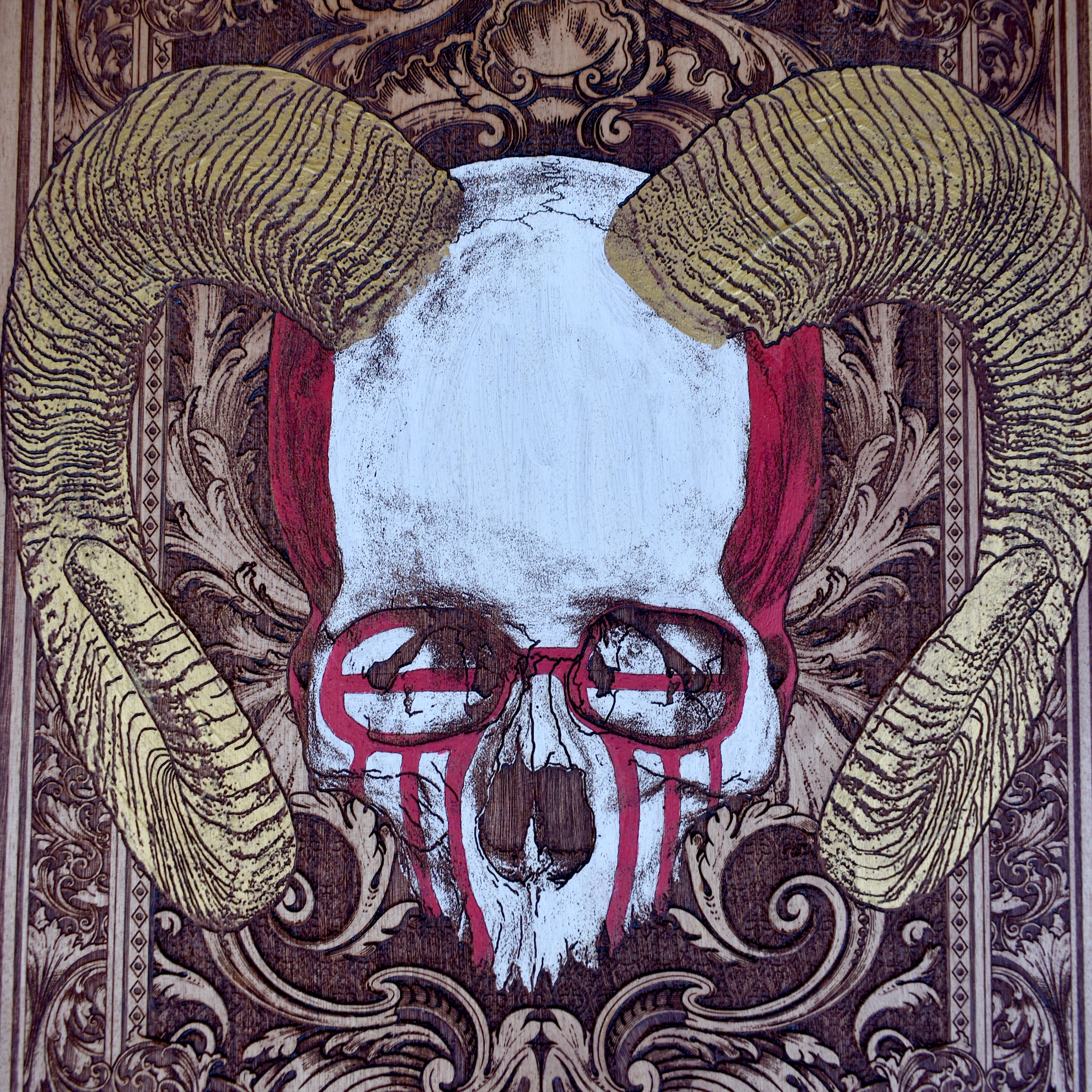 Detailed horned skull carving on rustic wood background