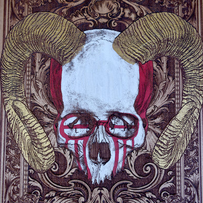 Detailed horned skull carving on rustic wood background