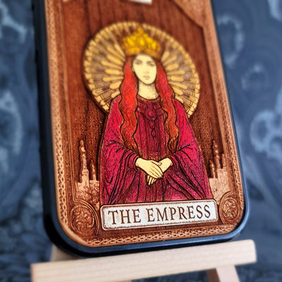 Deep laser engraved wooden phone case featuring The Empress tarot card with mystical celestial details on natural wood for iPhone and Samsung Galaxy models.