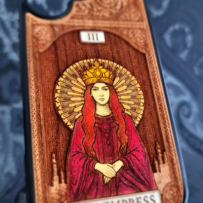 Deep laser engraved wooden phone case featuring The Empress tarot card with mystical celestial details on natural wood for iPhone and Samsung Galaxy models.