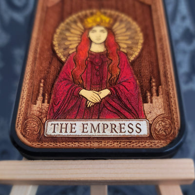 Deep laser engraved wooden phone case featuring The Empress tarot card with mystical celestial details on natural wood for iPhone and Samsung Galaxy models.