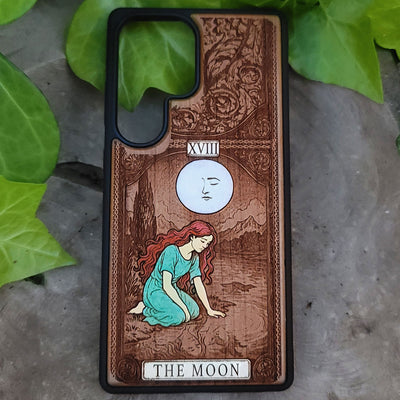 Phone case with 'The Moon' tarot card design on wood
