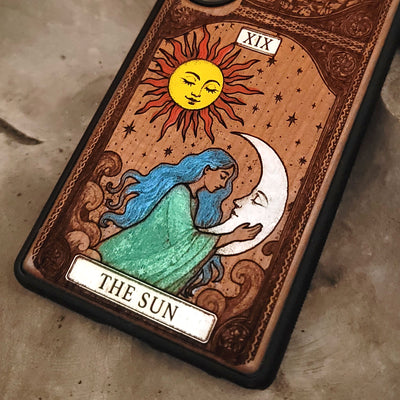 Decorative card featuring a sun and moon design with 'The Sun' text on a textured surface.