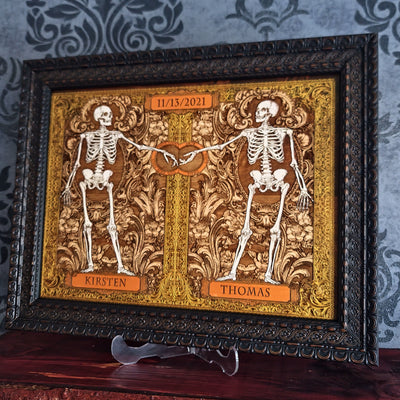Close up of laser engraved skeleton couple artwork with hand painted details