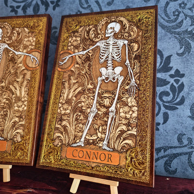 Custom anatomy wall art featuring two human skeletons with personalized name plaques