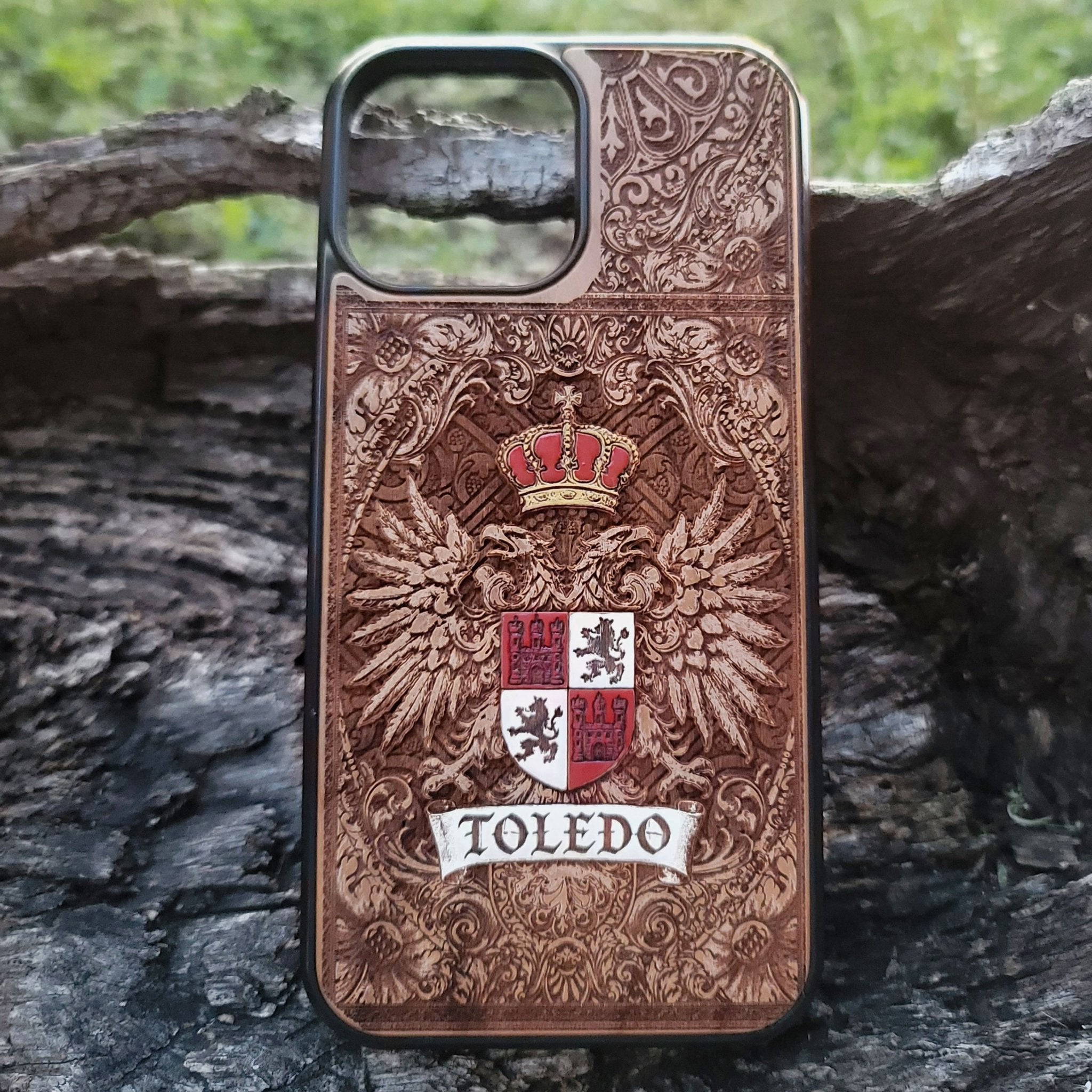Wood phone case engraved with Toledo family coat of arms and gothic accents.