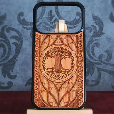 Wood phone case featuring a laser-engraved Tree of Life design surrounded by intricate Celtic-inspired patterns.