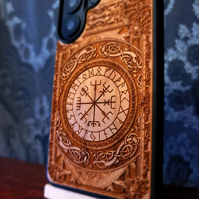 Deep laser engraved wooden phone case featuring the Vegvisir Viking compass with Nordic runic symbols for iPhone and Samsung Galaxy models.