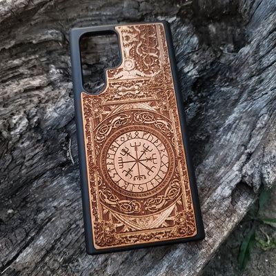 Viking-inspired wood phone case featuring the Vegvisir symbol surrounded by intricate Norse patterns and detailed engravings. Laser-engraved for durability and a unique design, this case is compatible with iPhone , 15, 14, 13, 12, 11, Pro Max, Mini, and Samsung Galaxy S, S24, S23, S22, S21, S20 Ultra, Plus, Note 20. A perfect protective accessory for fans of Norse mythology and Viking culture.