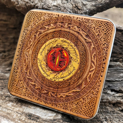 Close-up of Eye of Sauron symbol painted on wooden wireless charger.