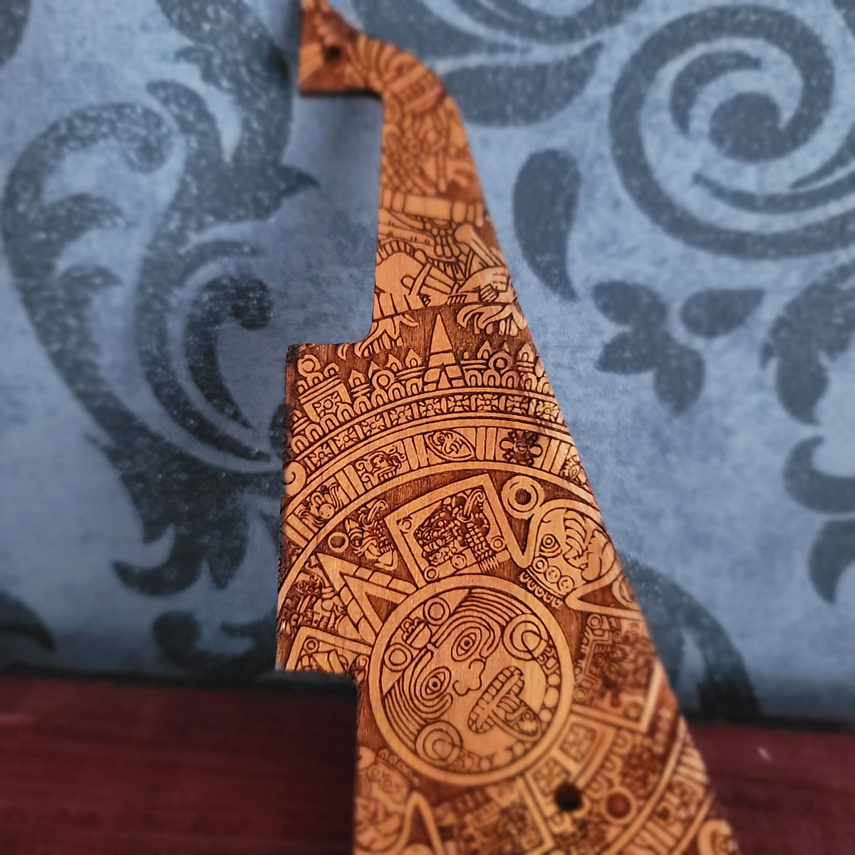 Engraved wood guitar scratchplate with intricate Aztec inspired geometric design