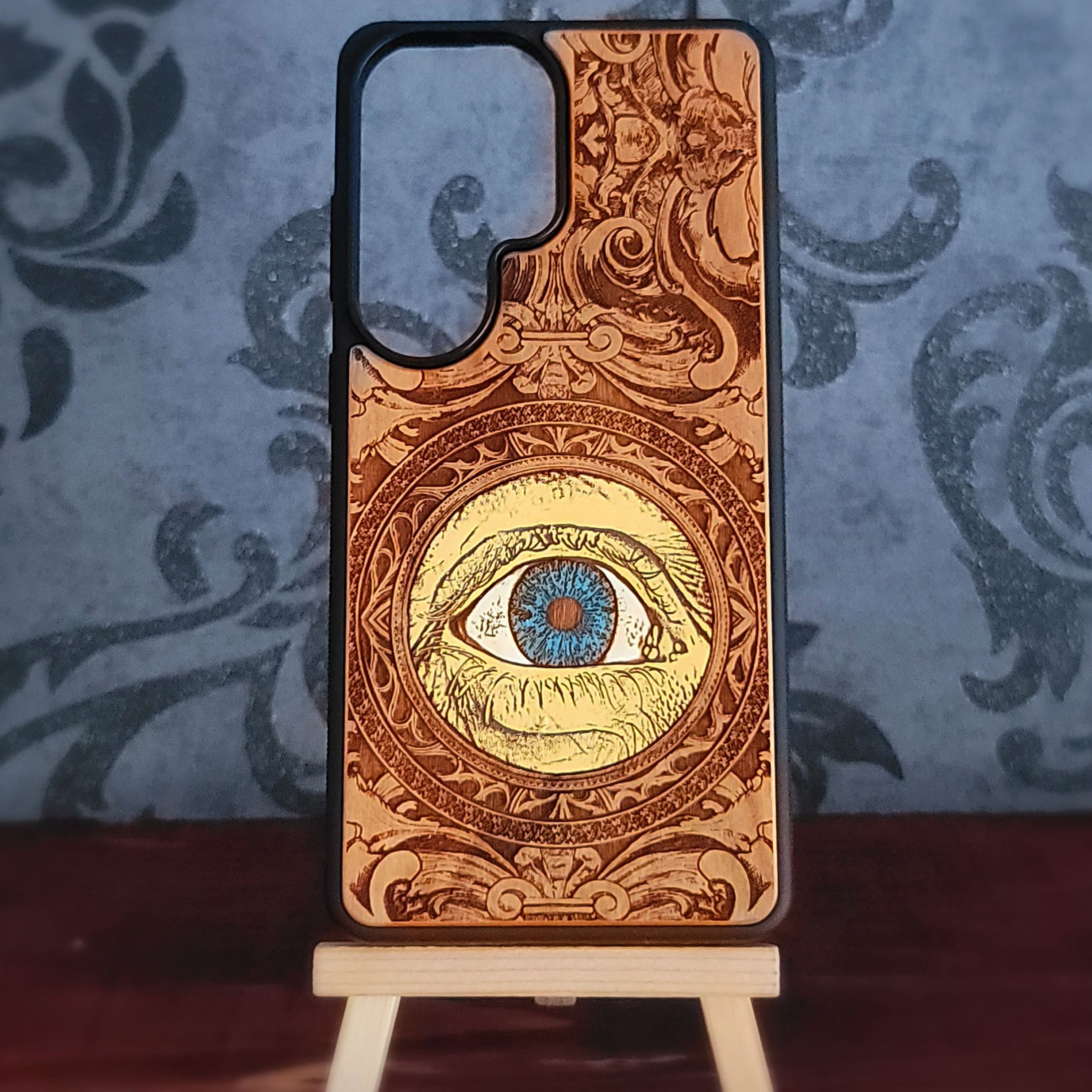 hand painted wood phone case featuring a human eye laser engraved