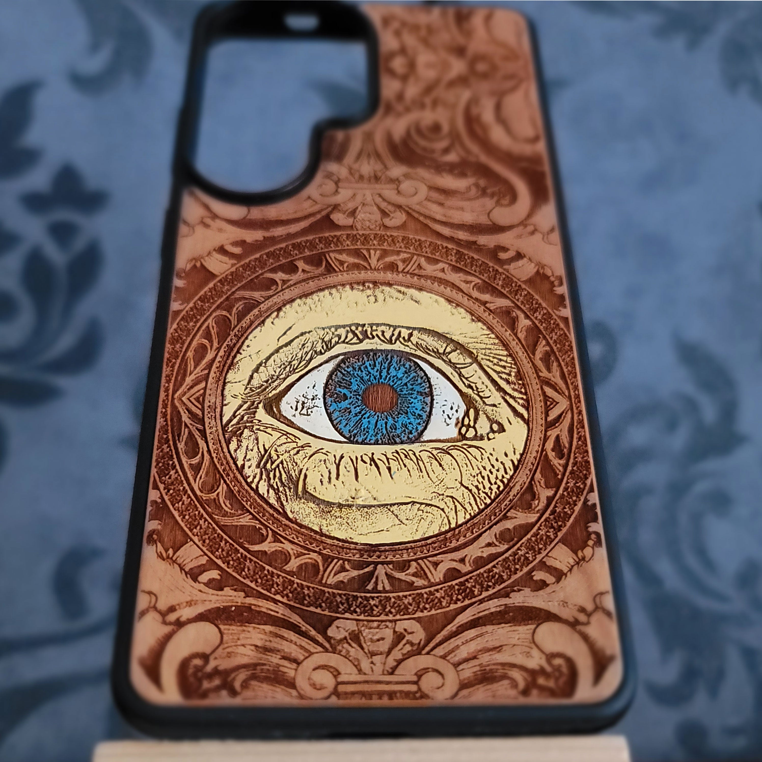 hand painted wood phone case featuring a human eye laser engraved