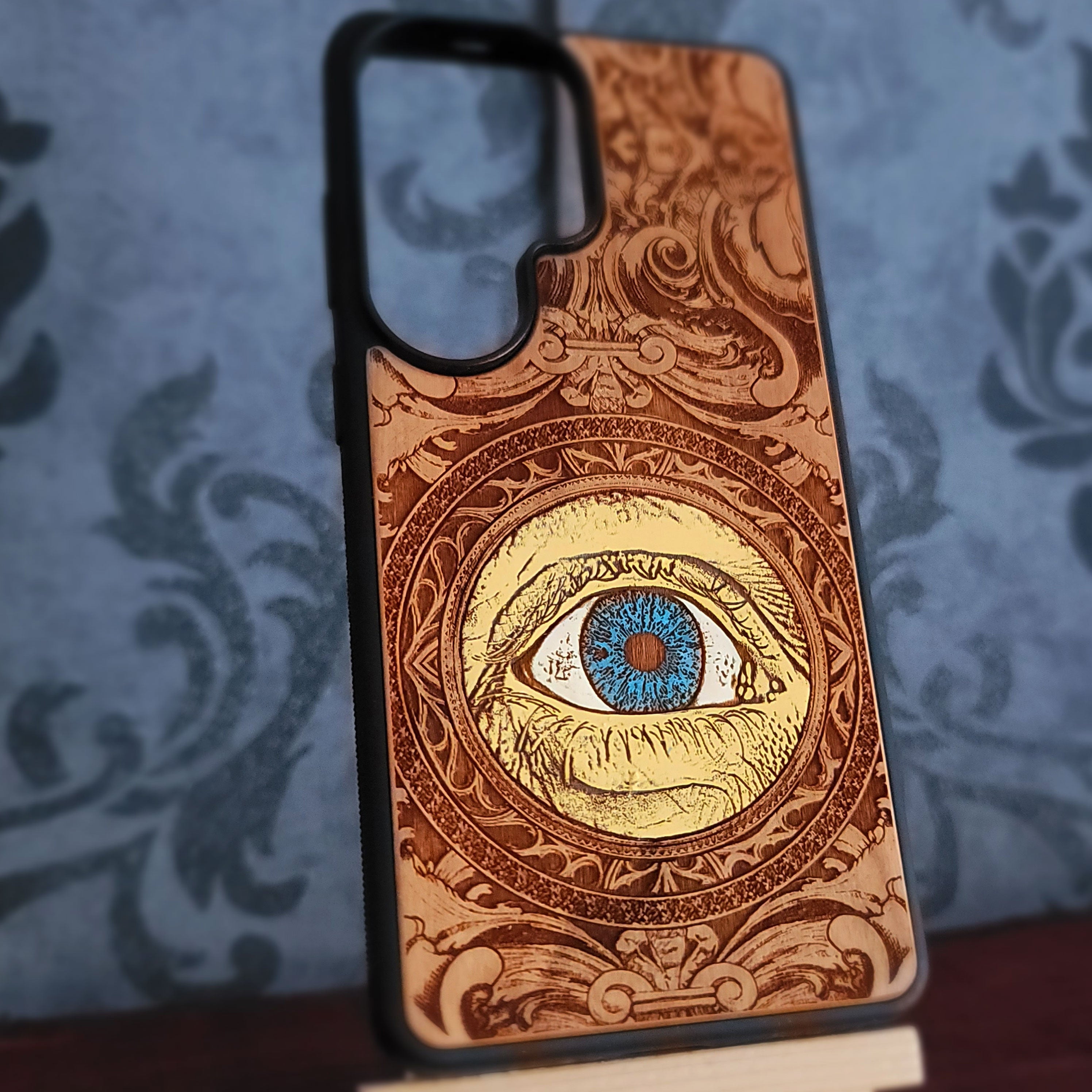hand painted wood phone case featuring a human eye laser engraved