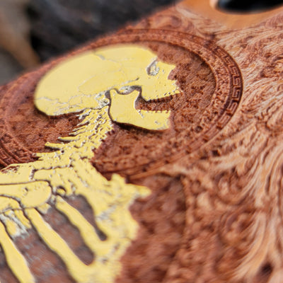 Close-up of intricate Gothic skeleton engraving on hand-finished cherry wood phone case