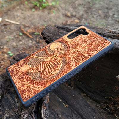 Hand-painted cherry wood phone case with intricate laser engraving of human skeleton and Gothic artwork.