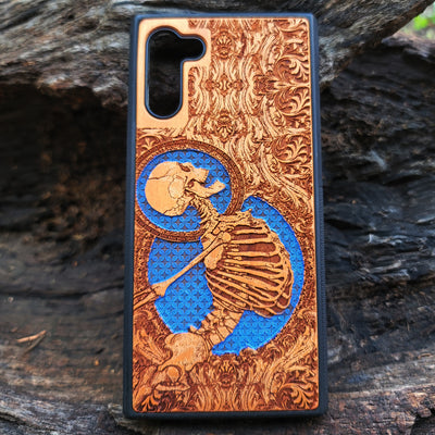 Gothic cherry wood phone case for iPhone & Samsung Galaxy with laser-engraved skeleton design.