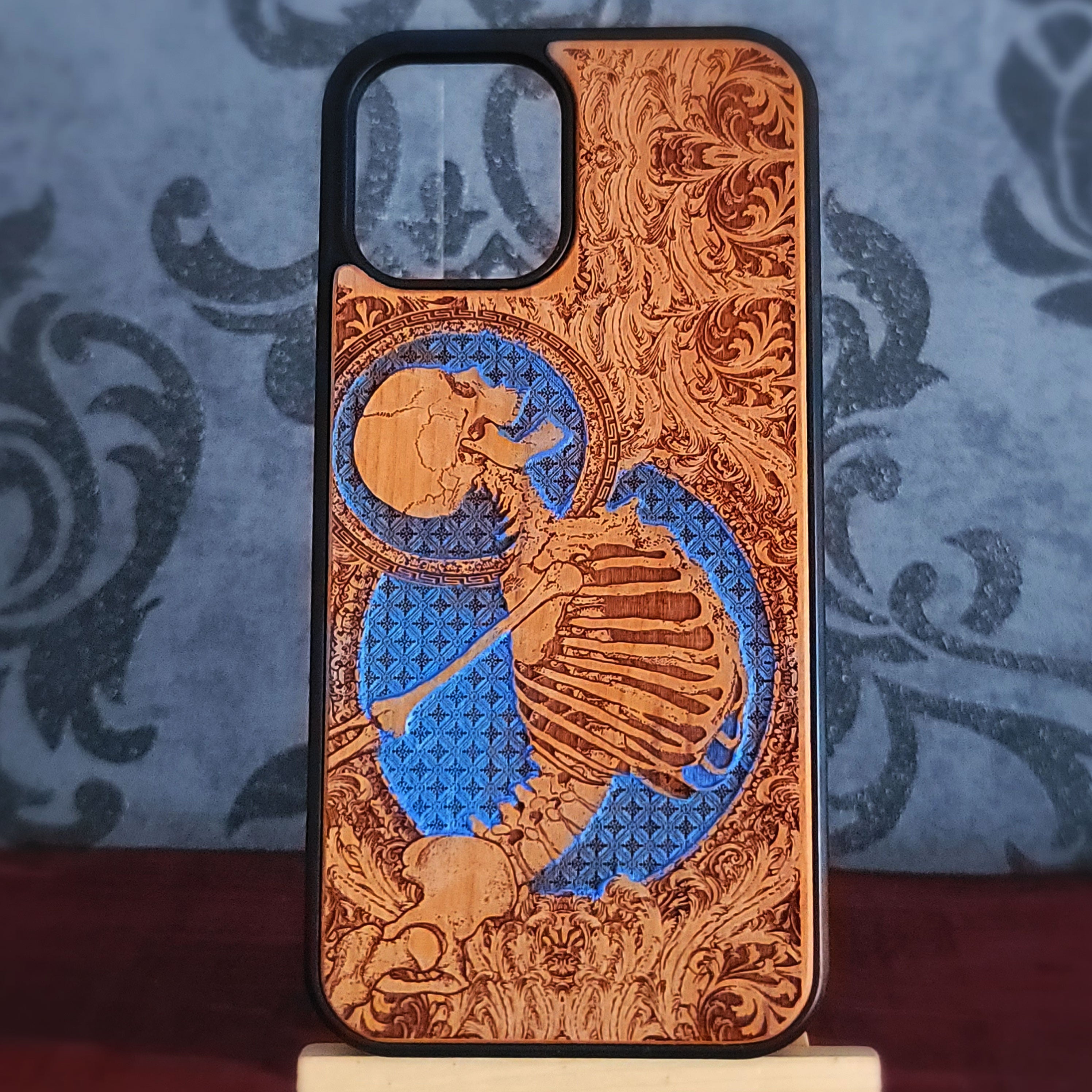 Anatomical skeleton engraved wood phone case with skull, rib cage, ornate vintage patterns and hand painted blue details